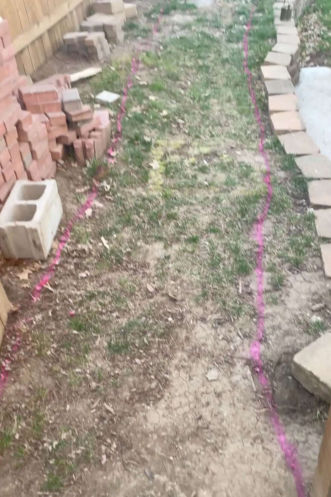 Spray painting with marking paint for where to put concrete sidewalk in my yard.